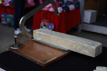 Handmade soap cutting in progress on table - 495804527
