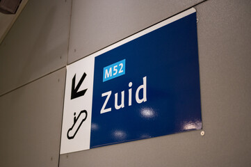 Sign for escalator and direction south on the north-south line subway in Amsterdam, Netherlands