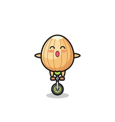 The cute almond character is riding a circus bike