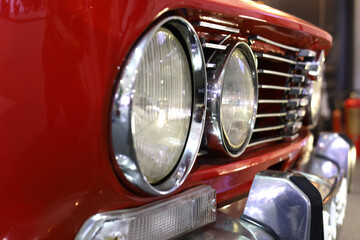 Front Side Head Lights An Bumper Of A Red Colored antique car - 495806501