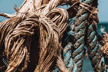 closeup shot of a fisher's boat ropes under a blue sky in Greece