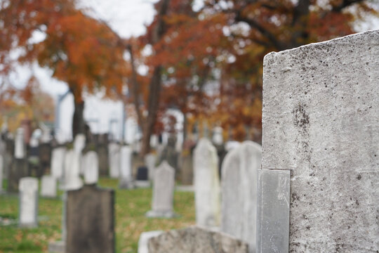 Closeup of cemetery gravestones in autumn