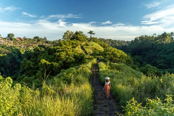 Woman hiking at the Bukit Campuhan on a sunny day in Bali, Indonesia