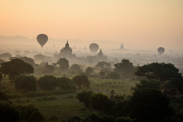 Hot air balloons hovering in the air above the plain of temples in Mandalay