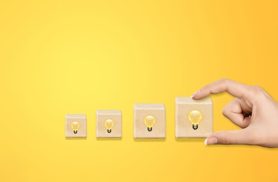 Concept creative idea and innovation. Pcked wooden cube block with light bulb icon