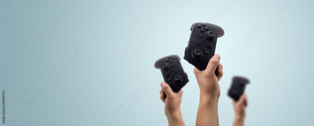 Wall mural hand holding a video game controller - concept winning in a game