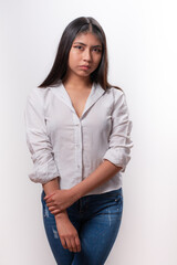 frontal portrait of Hispanic girl in studio isolated on white background with white shirt, alternative modeling concept.