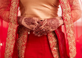 Fototapeta na wymiar Ill keep my husbands heart close to me. Cropped shot of an unrecognizable woman with mehendi painted on her hands on her wedding day.