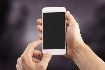 Technology Concept. Hand holds Mobile Phone with dark screen.