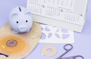 A bag for a colostomy, a stencil with a size of different diameters, medical scissors, a piggy bank...