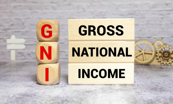 Wooden blocks with the word Gni and up arrow. Gross national income is the sum of a nation's gross domestic product