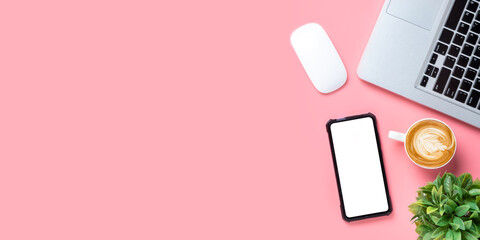 Office desk with laptop computer, Blank screen smart phone, cup of coffee, mouse on pink background, Top view with copy space, Mock up....