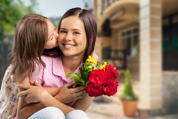 Fototapeta premium Happy woman child with tulips smiling with eyes. celebrating holiday at home