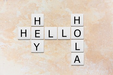Hey Hola Hello letters, tiles against blue background. © BillionPhotos.com