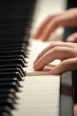 Fototapeta premium Child's hand presses the piano keys