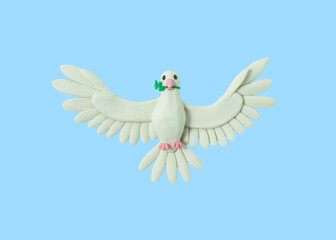 Peace dove made of white plasticine on a blue background. Peace on Earth. Not to war. handmade from plasticine