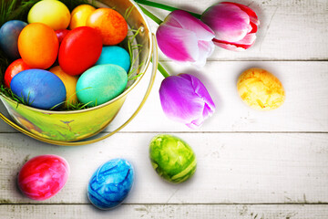 Easter background with colorful easter eggs on wooden background.