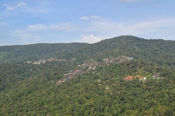 Fototapeta na wymiar Sakat village on mountain range in Doi Sakat, Pua District, Nan Province, THAILAND. View from road beside the hillside.