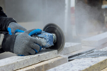 Construction site industrial tool an cutting off a granite slab in production - obrazy, fototapety, plakaty