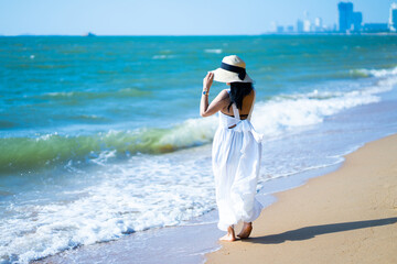 Fototapeta na wymiar girl in the sea on a beach on a clear day