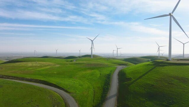 Windmill park green energy from drone view, windmill wind farm on green hills 4K
