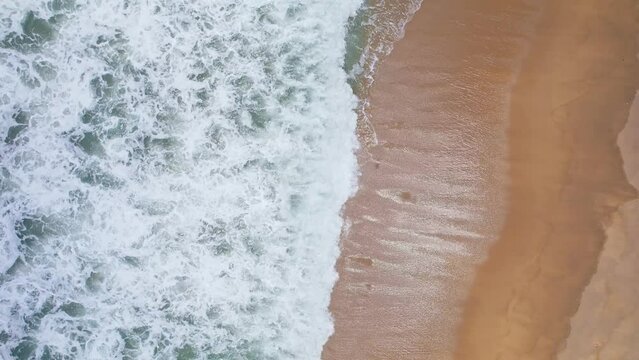 Aerial view top down of Local southern Thai fisherman uses his handmade fish trap and cicada sea on a beach in Phuket Thailand