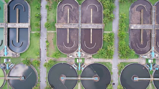 Aerial view High angle view Top down drone shot of the sewage treatment plant.The Solid contact clarifier tank type sludge recirculation in water treatment plant. Industrial wastewater treatment plant