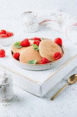 Fresh pancakes for breakfast with raspberry on light background. Summer healthy food
