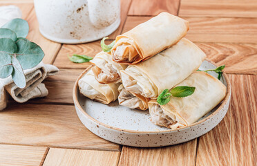 Mini apple strudel with pecans and mint on wooden table. Viennese pastry.