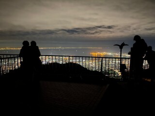 a couple and night view of Kobe