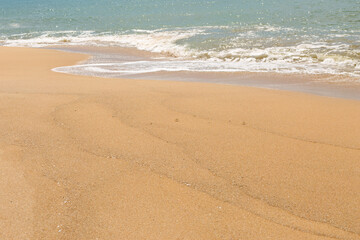 Fototapeta na wymiar Yellow sand beach. Sea tidal bore.
