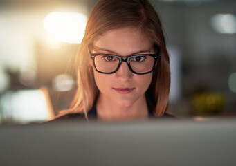 Dont wish for it, work for it. Cropped shot of a young designer working late in the office.