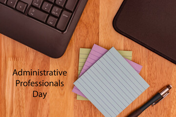 Administrative Professionals Day, Secretaries Day concept showing computer keyboard, mouse mat, sticky notes and pencil