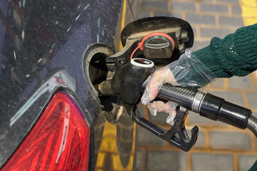 Fuel hose for refuel at a gas station. Gasoline and diesel prices rise.