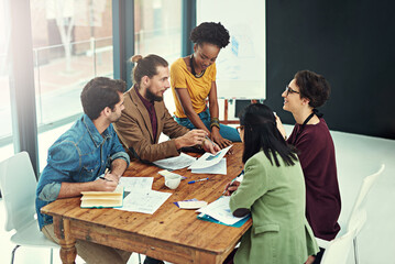 Innovation is crucial to the continuing success of any business. Cropped shot of a group of young creatives having a meeting in a modern office.