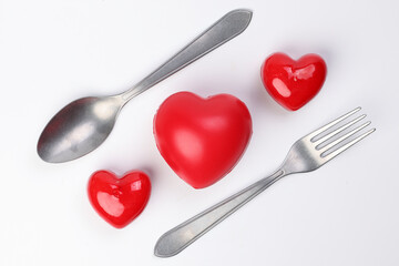 small large three dimension 3d red hart shape symbol with fork spoon on top of white background...