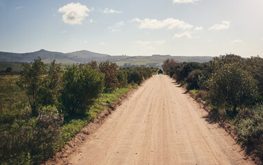Fototapeta na wymiar The muddiest road may end up somewhere amazing. Shot of an empty farm.