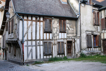 Medieval half-timbered houses in poor repair in a French town