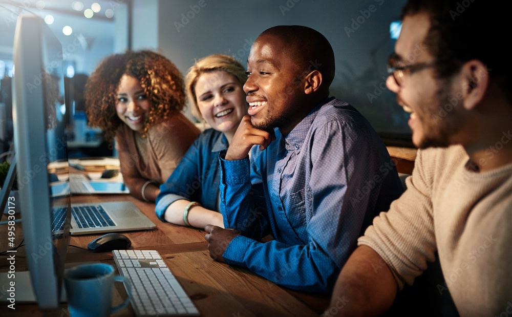 Poster working around the clock. shot of a team of young businesspeople working late in the office.