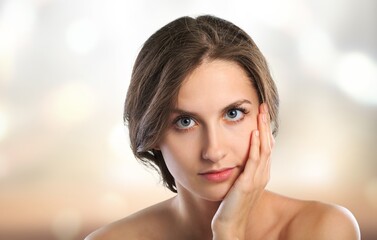 Beautiful young woman with clean fresh skin on blur bokeh background, Face care, Facial treatment, Cosmetology, beauty and spa concept