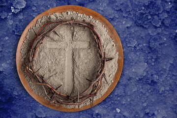 Christian cross with wooden wreath of jesus on plate