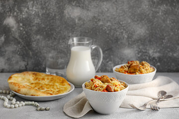 Tasty Asian pilaf and flatbread on grunge background
