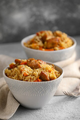 Bowl with tasty Asian pilaf on table