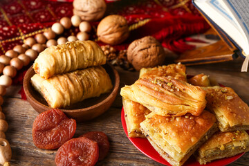 Tasty Eastern sweets on wooden table