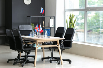 Interior of office with British, Canadian and Russian flags on table