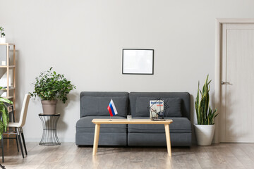 Interior of modern living room with Russian flag on table