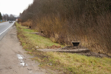 Base for a new metal pole for street lighting. A post buried in the ground, installation of a new...