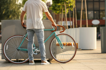Young man with bicycle in city
