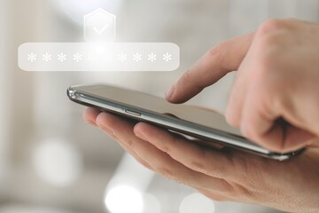 Virtual safety shield icon while access on phone with laptop for validate password, Identity verification, cybersecurity with biometrics authentication technology. Authentication concept.