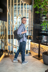 Fototapeta na wymiar A man in a casual clothes with a backpack